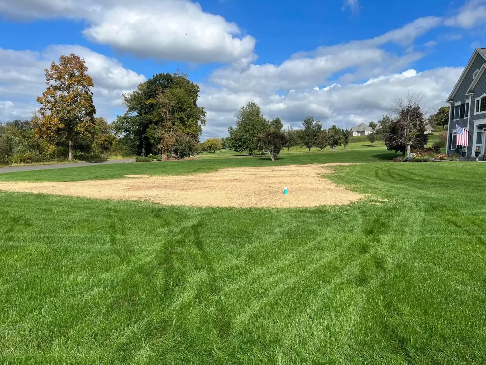 A finished, restored septic field reseeded into a clean green Connecticut lawn after a Summit Septic installation