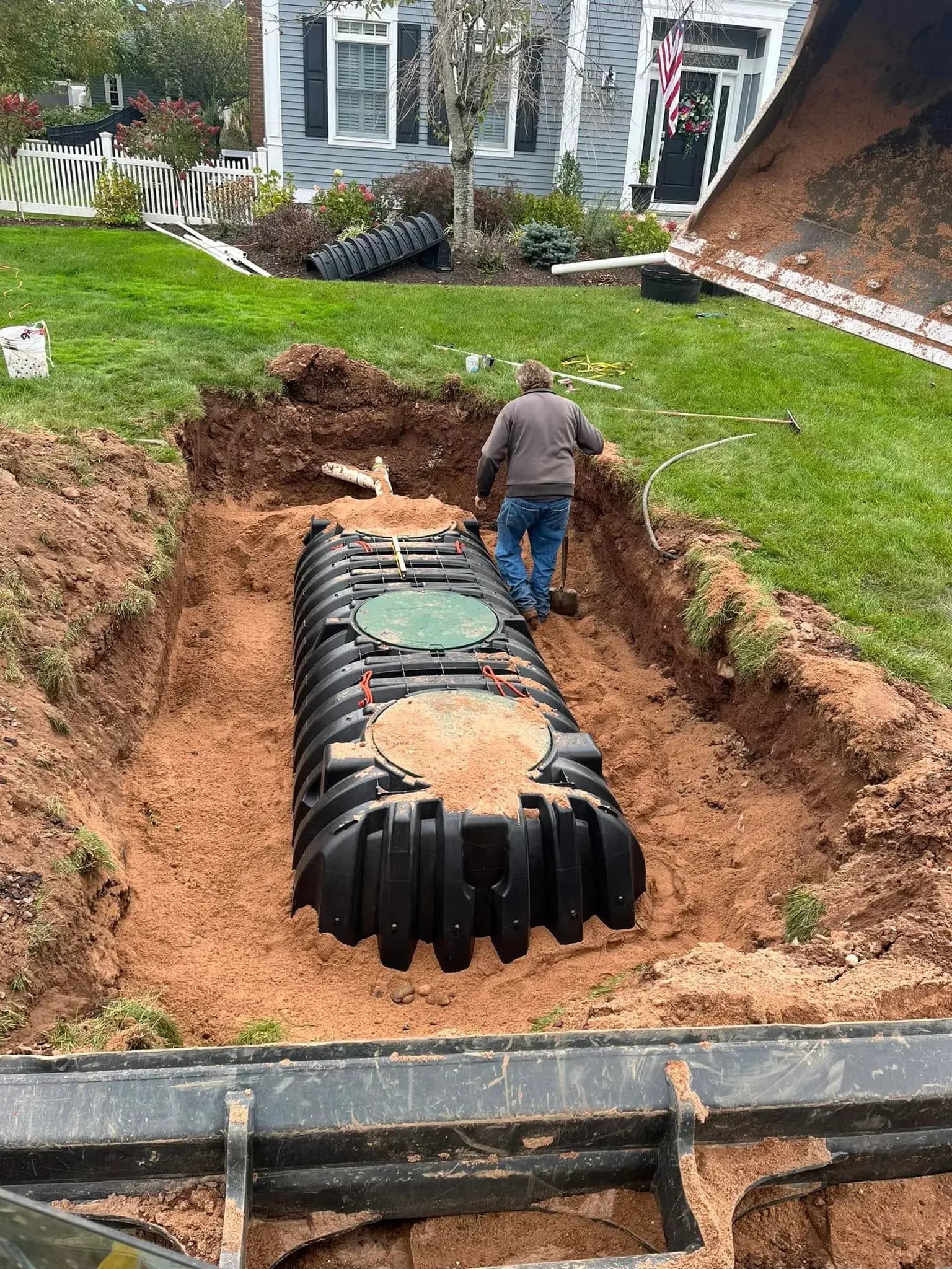 A residential septic tank with its access lids exposed for service in a Connecticut yard